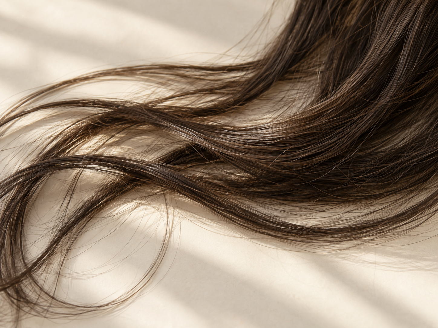Close-up hair strands illustrating a coated or waxy after-wash feel
